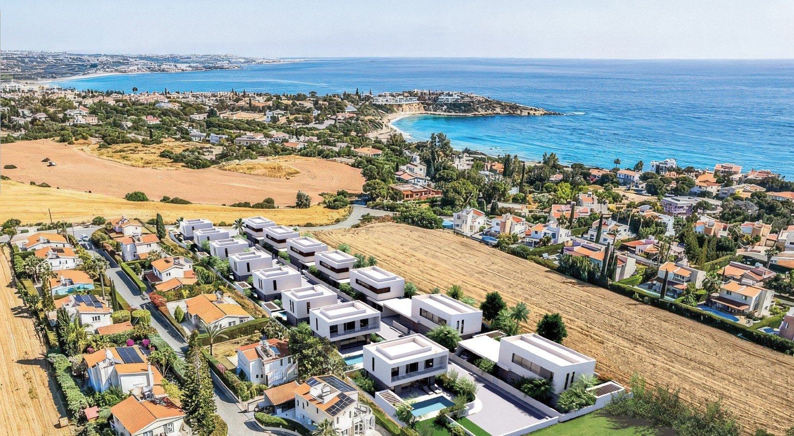 Aerial view of the 15 Corallia Villas at Coral Bay, Peyia, with the sea and coastline beyond